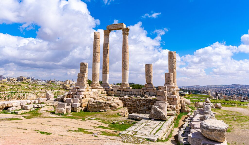 View of the ancient Temple of Hercules at the Amman Citadel under a clear blue sky.