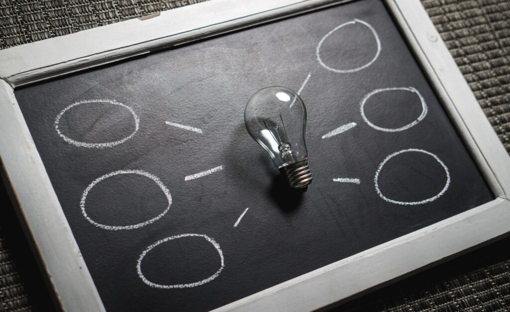 Chalkboard with a light bulb symbolizing ideas and creativity. Perfect for education themes.